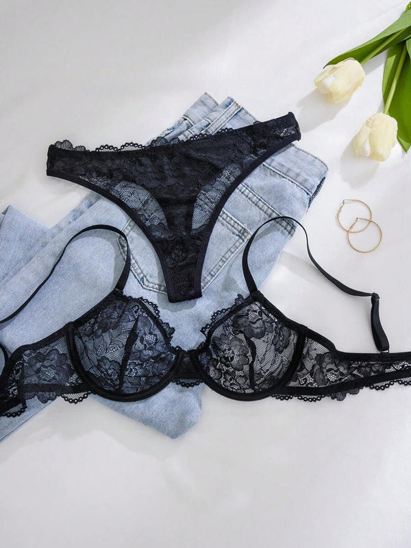 Conjunto íntimo negro con tanga y sujetador estilo fantasía-elegante.