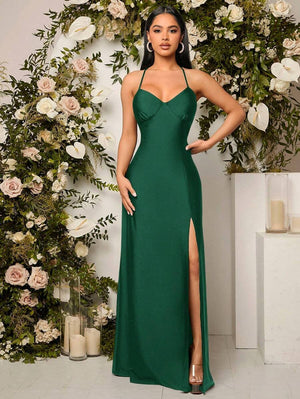 Vestido verde oscuro largo con tirantes finos y abertura vista frontal.