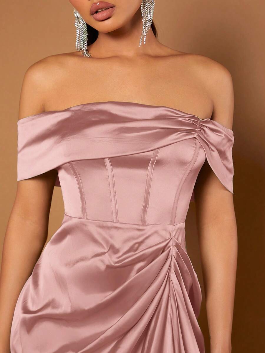 Vista completa de una modelo luciendo un vestido satinado rosa vieja de hombros descubiertos y falda asimétrica.
