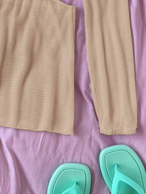Primer plano de la falda ajustada de un vestido corto de punto color beige.