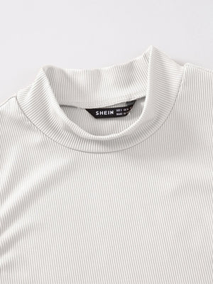 Detalle del cuello alzado y las costuras del top crop blanco canalé