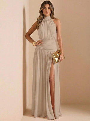 Detalle de la falda larga y fluida de un vestido beige con una pronunciada abertura en la pierna.