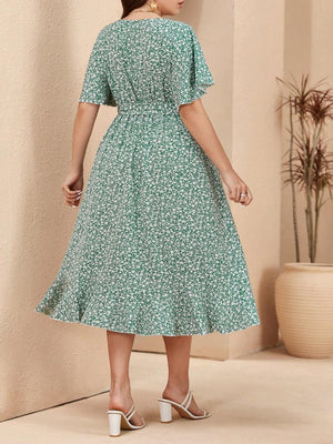 Vista trasera del vestido verde floral, mostrando el ajuste envolvente y el diseño con cinturón.