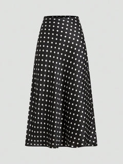 Falda midi negra con estampado de lunares blancos vista de frente.