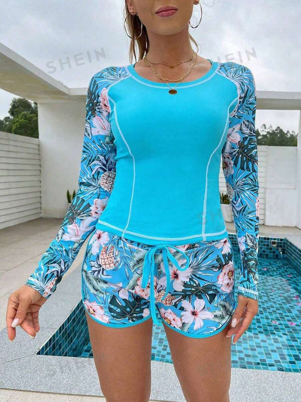 Detalle del torso de un top de baño tipo rash guard color turquesa con costuras blancas.