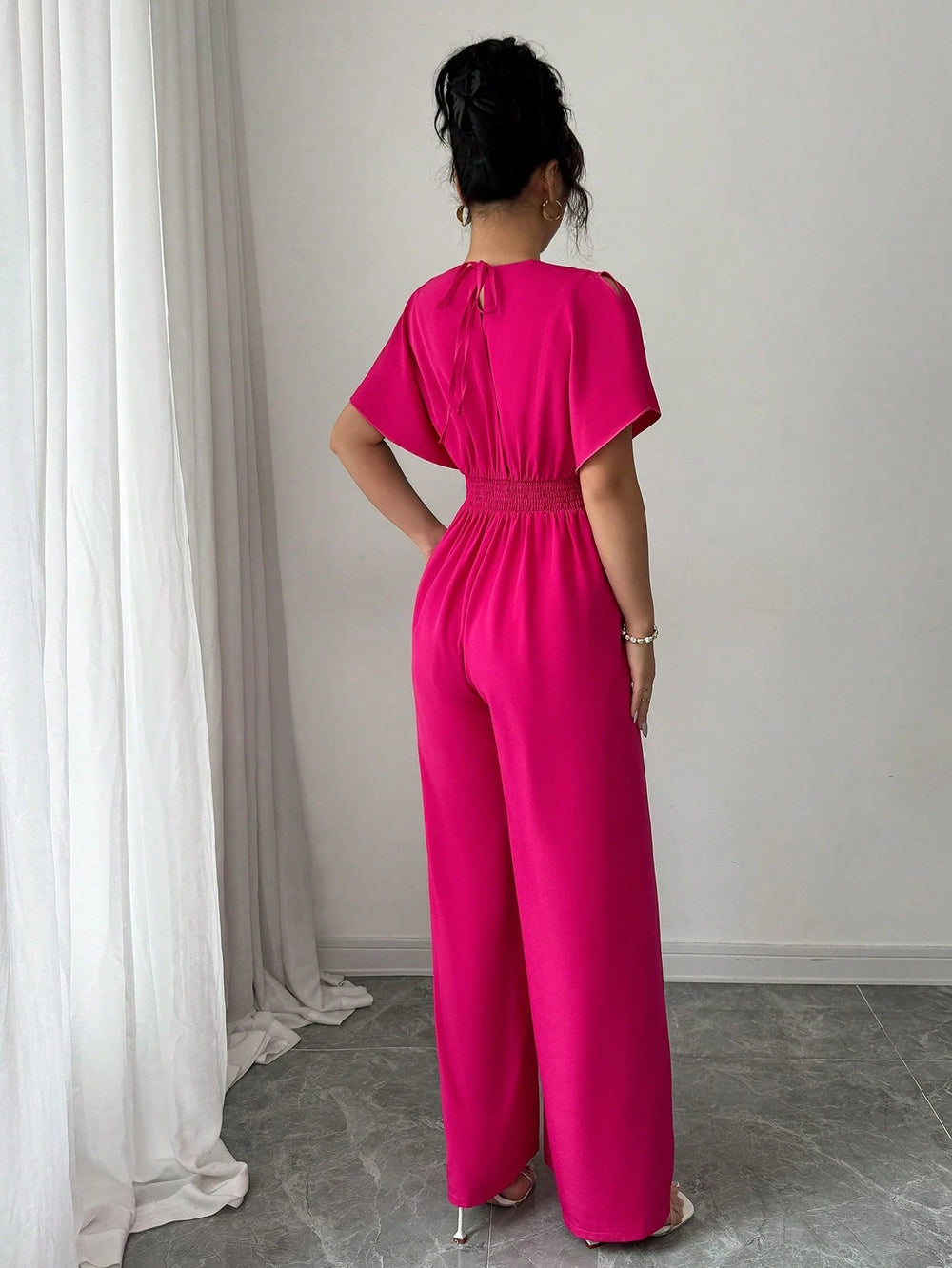 Jumpsuit rosa fucsia elegante para mujer.
