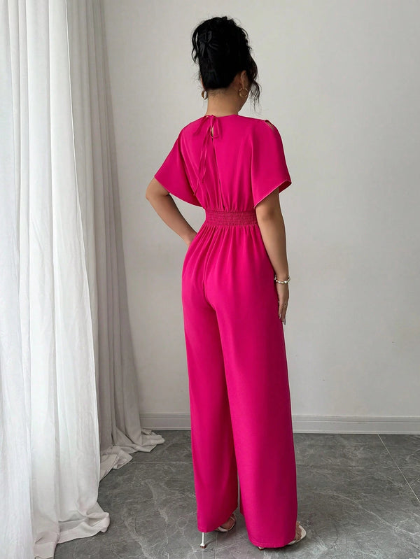 Vista posterior jumpsuit rosa fucsia elegante.