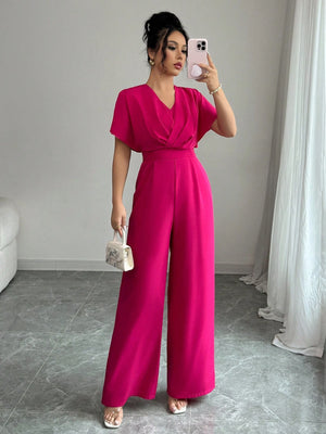 Jumpsuit elegante rosa fucsia de pierna ancha.