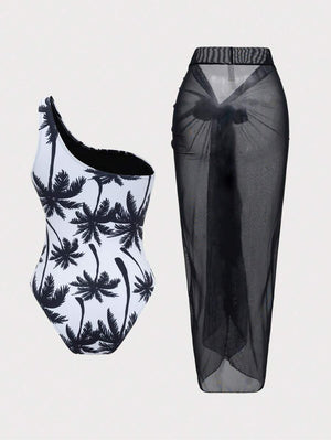 Primer plano del traje de baño de una pieza con escote asimétrico y estampado tropical de palmeras.