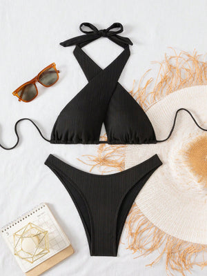 Bikini negro con escote cruzado y corte alto.