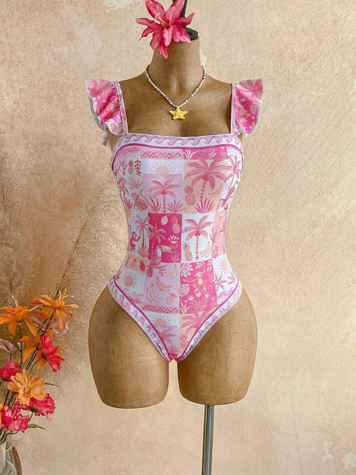 Traje de baño de una pieza con estampado tropical rosa y blanco en un maniquí.