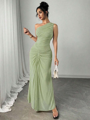 Detalle de la falda larga y fluida de un vestido elegante color verde con drapeado en la cadera.