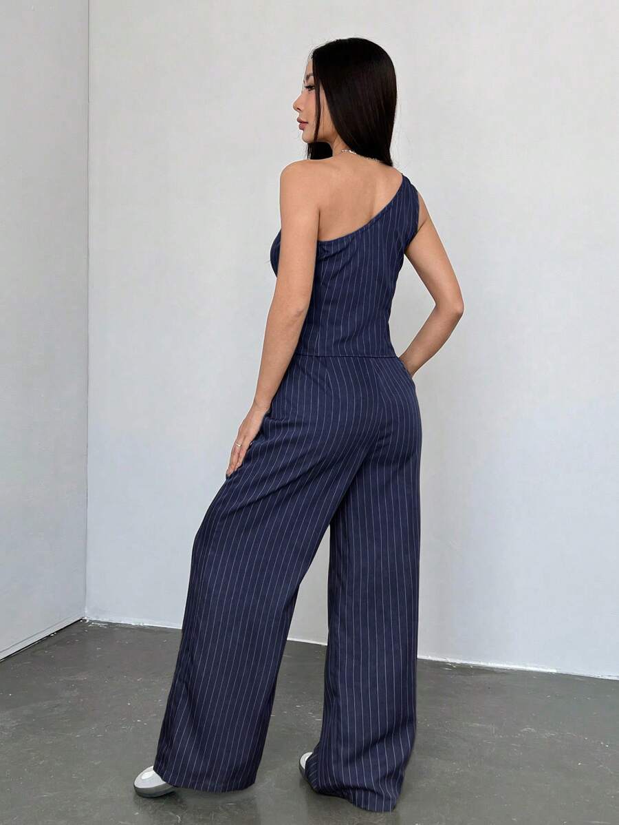 Imagen frontal del conjunto elegante azul marino con blusa asimétrica y pantalón.