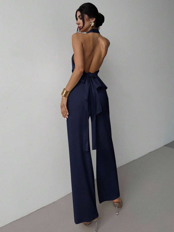 Primer plano del top halter con lazo en la cintura de un conjunto azul marino elegante.