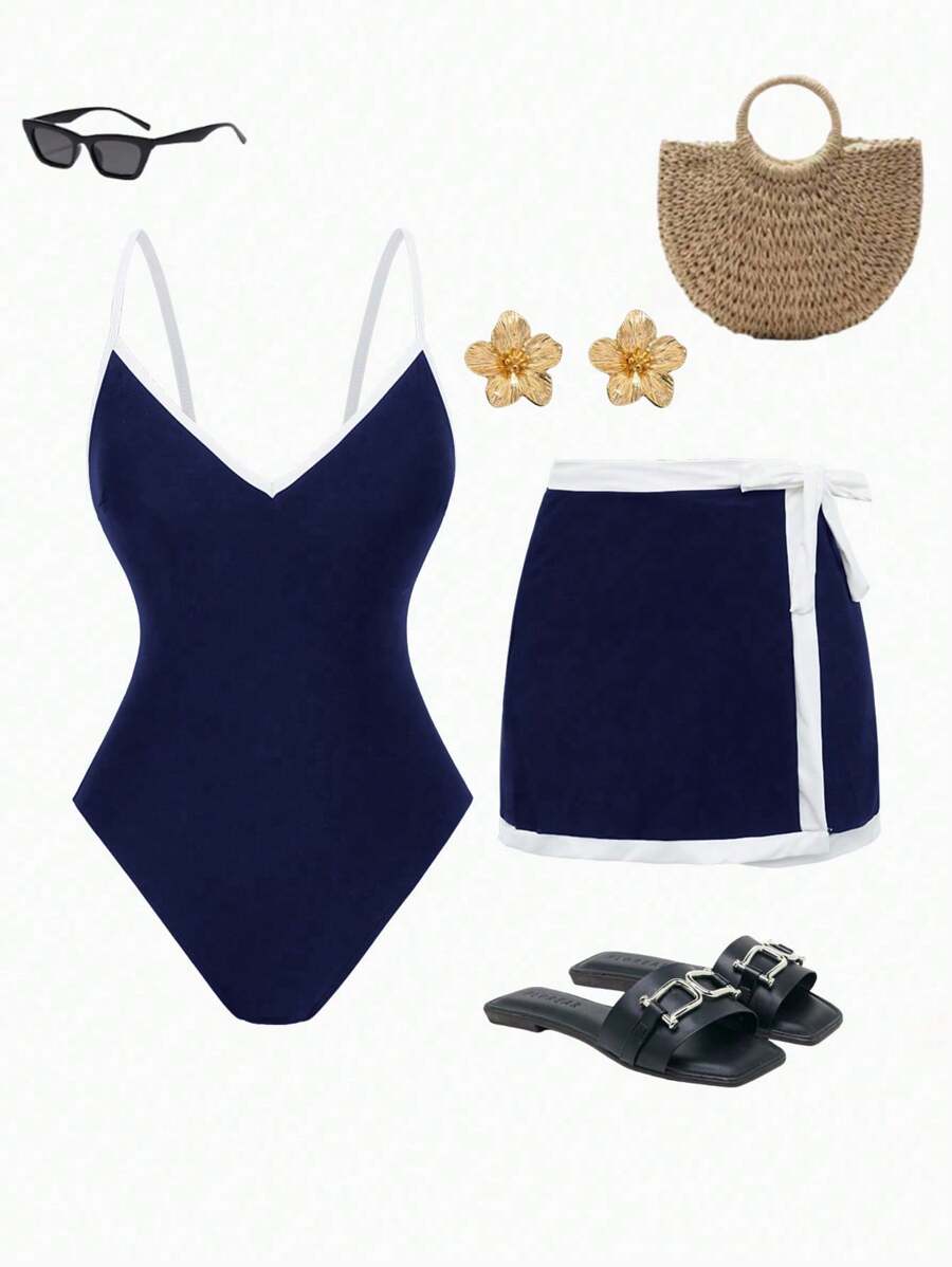 Look completo de conjunto de traje de baño azul marino con falda, sandalias negras, bolso de paja y lentes de sol.