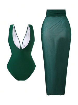 Vista frontal del traje de baño de una pieza color verde oscuro, mostrando el fruncido en la cintura y el adorno metálico.