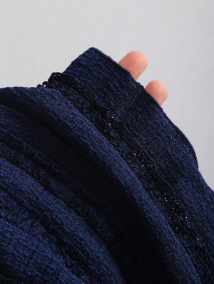 Detalle de la tela tricotada azul marino del vestido mini elegante.