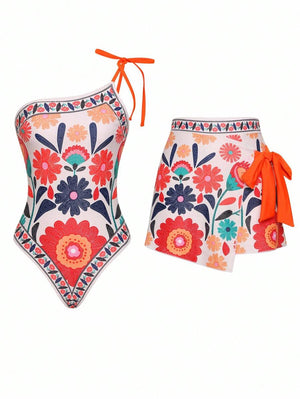 Conjunto de traje de baño asimétrico de una pieza y falda corta a juego con vibrante estampado floral multicolor.