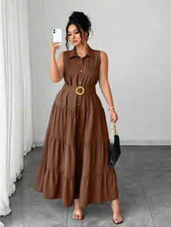 Mujer modelando un vestido camisero maxi de color café, sin mangas y con cinturón.