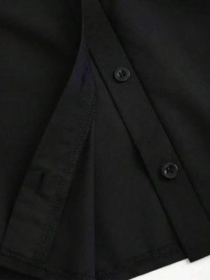 Detalle del cuello camisero y botones superiores del vestido negro.