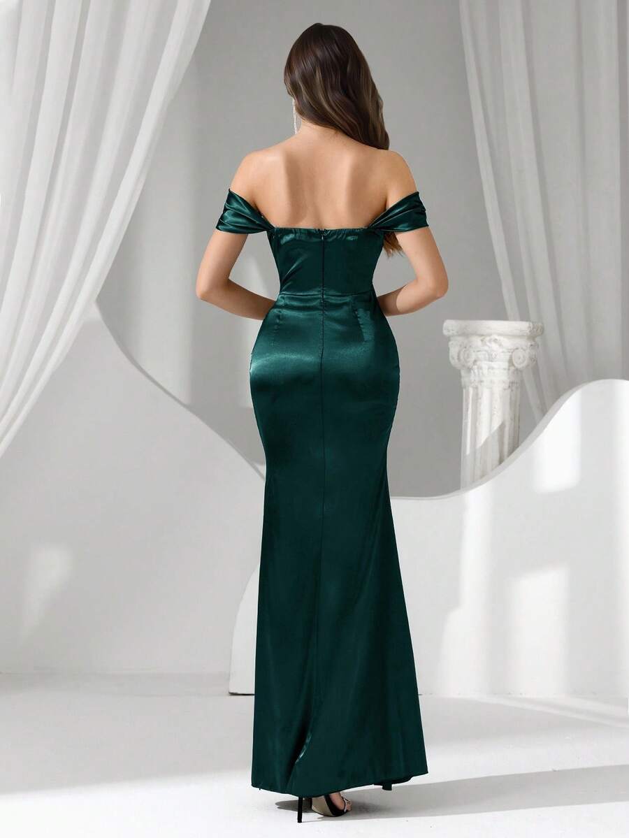 Vista completa de una modelo luciendo un vestido de noche largo verde esmeralda con hombros descubiertos y corsé.