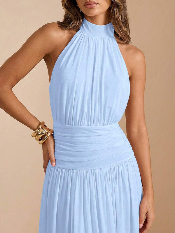 Modelo luciendo un vestido largo de fiesta azul cielo combinado con accesorios dorados.