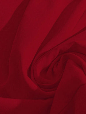 Primer plano del bajo con volantes del romper corto en color rojo vino.