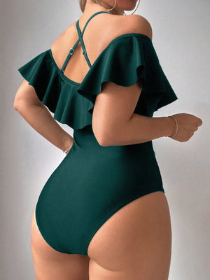 Vista posterior bikini entero cruzado con volante exagerado agua verde azul