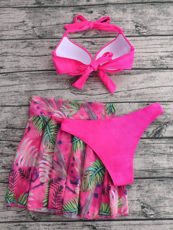 Detalle del top halter rosa con nudo frontal y estampado tropical.