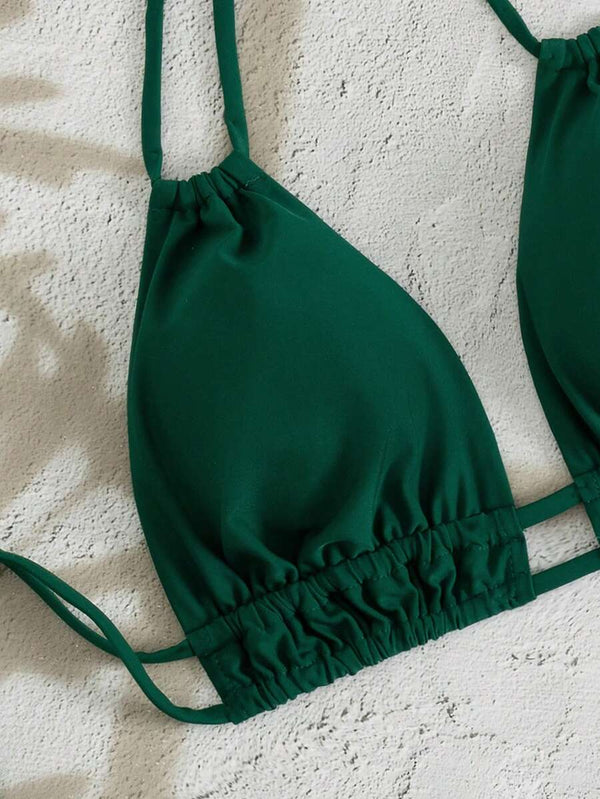 Primer plano de la braga de bikini de tiro alto con diseño cruzado en V en color verde.
