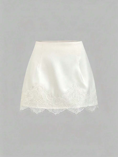 Minifalda blanca satinada con borde de encaje vista frontal.