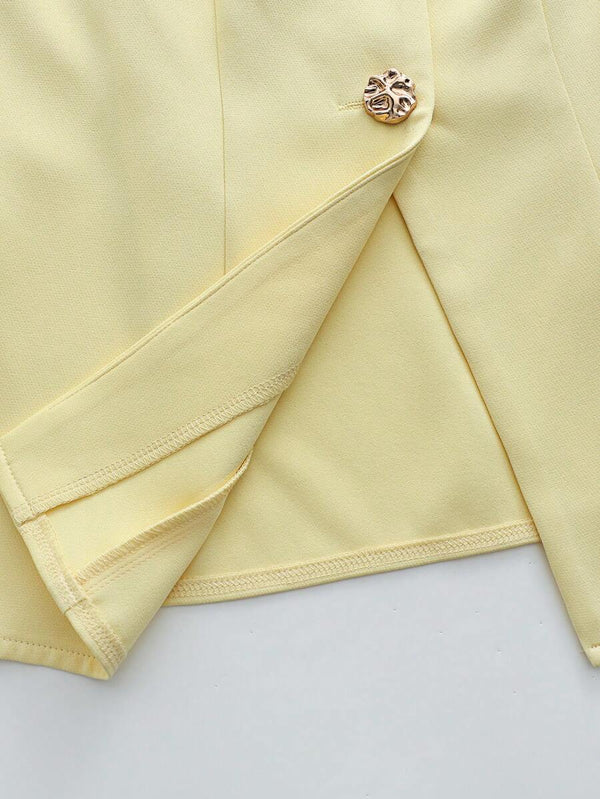 Vista de cerca del short de talle alto con pinzas en color amarillo pálido.