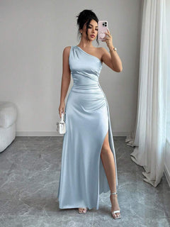 Mujer modelando un vestido largo celeste de un solo hombro con fruncido en la cintura.