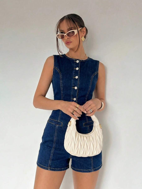 Detalle de los shorts y los bolsillos de un romper de mezclilla azul oscuro ajustado.