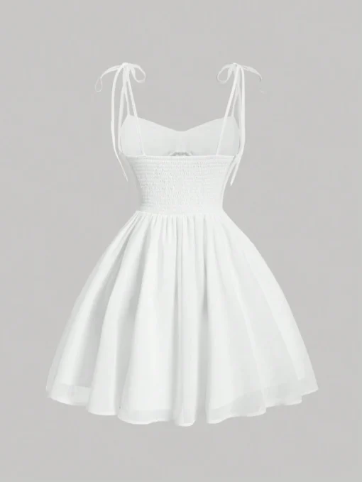 Vestido blanco corto de tirantes finos, vista trasera con detalle fruncido.
