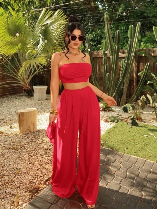 Mujer usando conjunto rojo bohemio sin tirantes en un jardín con cactus.