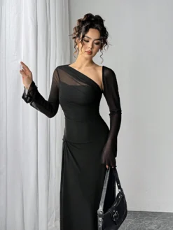Detalle superior del vestido elegante negro asimétrico con gasa en el escote
