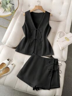 Conjunto negro casual de top con nudos y short cruzado sobre sillón blanco