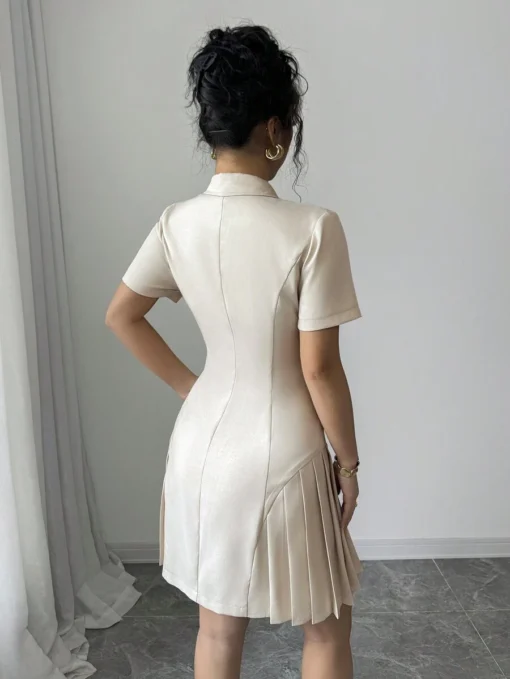 Vista trasera del vestido corto elegante albaricoque con plisado.