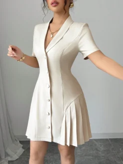 Detalle del escote y botones del vestido corto elegante albaricoque.